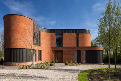 Inspiration for a modern brick house exterior in Oxfordshire.