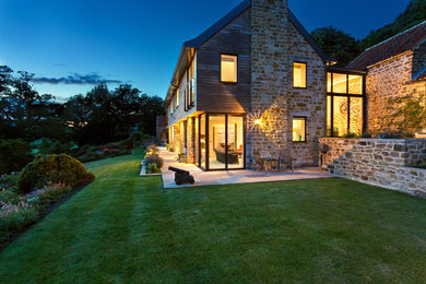 Inspiration for a medium sized and beige contemporary two floor detached house in Other with stone cladding.