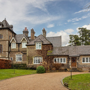 Inspiration for a large and brown victorian detached house in Other with three floors, stone cladding, a hip roof and a shingle roof.