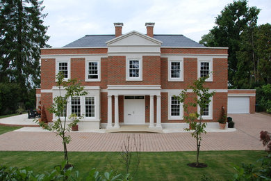This is an example of a large traditional house exterior in Surrey.
