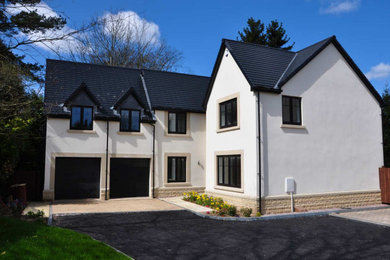 This is an example of a large and white contemporary two floor render detached house in Other with a tiled roof.