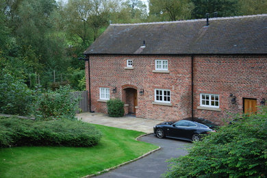 This is an example of a large traditional two floor brick house exterior in West Midlands.
