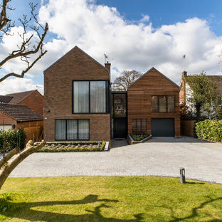 Inspiration for a large contemporary two floor detached house in Surrey with mixed cladding and a pitched roof.
