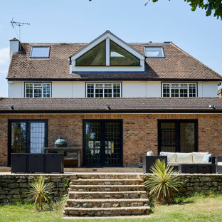 This is an example of a classic two floor detached house in London with mixed cladding, a pitched roof, a shingle roof and a brown roof.