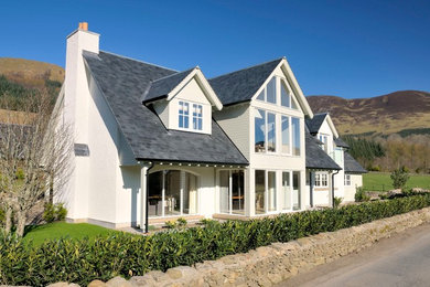 Inspiration for a large and white classic two floor house exterior in Other with mixed cladding and a pitched roof.