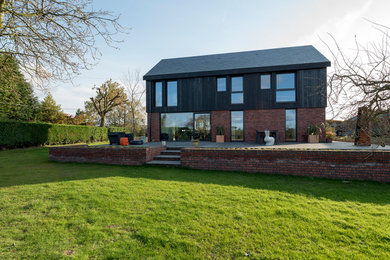 Design ideas for a contemporary house exterior in Manchester.
