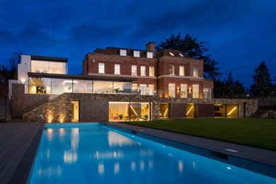 Inspiration for an expansive and red contemporary brick detached house in London with three floors.