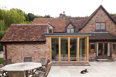 Inspiration for a medium sized modern house exterior in Hertfordshire with metal cladding.
