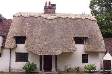 Photo of a medium sized and white traditional two floor house exterior in Cambridgeshire with a pitched roof.