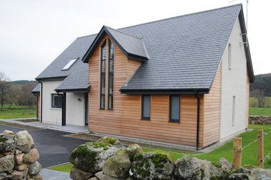 Medium sized and multi-coloured contemporary two floor detached house in Other with wood cladding, a pitched roof and a tiled roof.