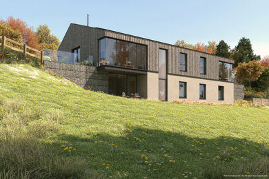 This is an example of a large contemporary two floor detached house in Other with wood cladding and a pitched roof.