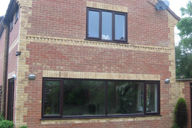 Photo of a medium sized modern two floor brick house exterior in Other.