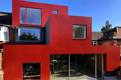 Photo of a red modern semi-detached house in London with metal cladding.