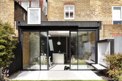 Design ideas for a small and multi-coloured contemporary semi-detached house in London with a flat roof.