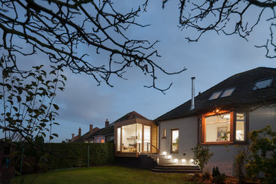 Inspiration for a large and beige contemporary two floor house exterior in Edinburgh with wood cladding and a flat roof.