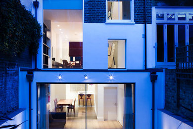 Design ideas for a large contemporary render house exterior in London with three floors.