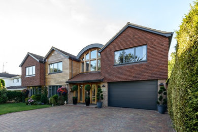 Large contemporary two floor house exterior in Hertfordshire with wood cladding.