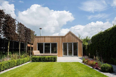 Inspiration for a contemporary bungalow house exterior in Buckinghamshire with wood cladding.