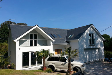 This is an example of a medium sized and white contemporary two floor render house exterior in Cornwall.