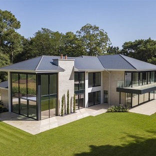 Design ideas for an expansive and beige contemporary two floor detached house in Devon with mixed cladding.