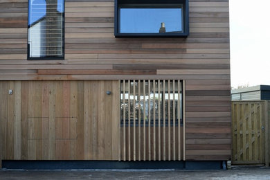 Photo of a house exterior in Sussex with wood cladding.