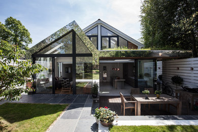 Medium sized and white contemporary two floor detached house in London with metal cladding.