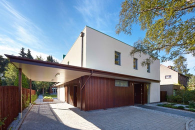 Idee per la villa contemporanea a due piani di medie dimensioni con rivestimento in stucco e tetto piano