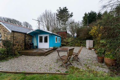 Immagine della facciata di una casa piccola blu country a un piano con rivestimento in legno