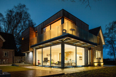 Medium sized contemporary two floor house exterior in Other.