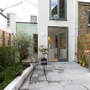 Design ideas for a medium sized and white contemporary two floor render terraced house in London.