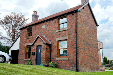 Inspiration for a small classic two floor house exterior in West Midlands with mixed cladding.