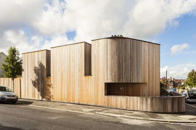 Design ideas for a medium sized contemporary two floor house exterior in London with wood cladding.