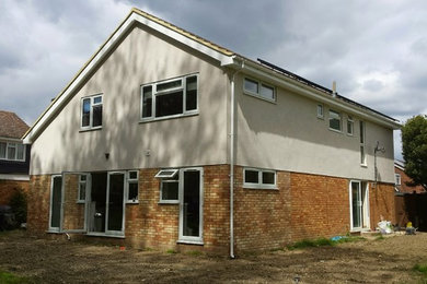 Design ideas for a large contemporary house exterior in Cambridgeshire.
