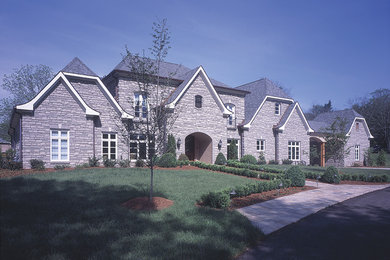 Inspiration for a large and gey classic house exterior in Nashville with three floors, stone cladding and a hip roof.