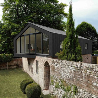 This is an example of a small and black contemporary two floor detached house in Wiltshire with mixed cladding and a pitched roof.