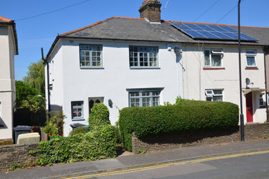 Photo of a medium sized and white traditional two floor render semi-detached house in Other.