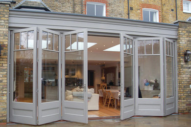 Sliding folding doors with a panel base design and fascia above.
