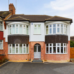 This is an example of a white traditional two floor semi-detached house in London with a pitched roof and a tiled roof.