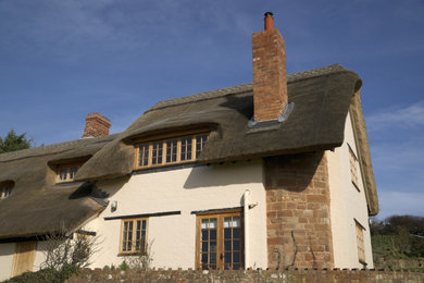 Inspiration for a small and beige classic two floor render detached house in Other with a pitched roof.