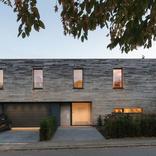 Design ideas for a medium sized and gey contemporary two floor detached house in Hertfordshire with wood cladding and a flat roof.