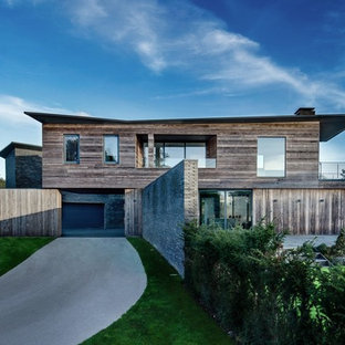Inspiration for a contemporary two floor detached house in Hampshire with wood cladding.