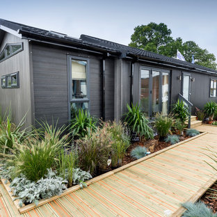 Inspiration for a small and black contemporary one floor tiny house in Other with a hip roof.