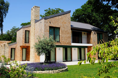 Brown contemporary two floor house exterior in Hampshire with wood cladding.