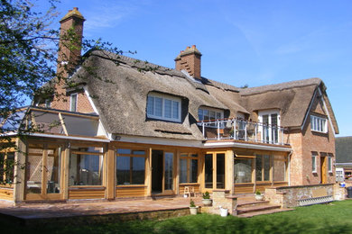 Photo of a brown and large farmhouse two floor brick detached house in Kent with a pitched roof.