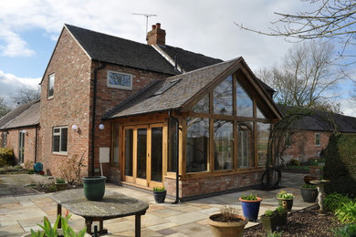 This is an example of a medium sized traditional two floor brick detached house with a pitched roof and a tiled roof.