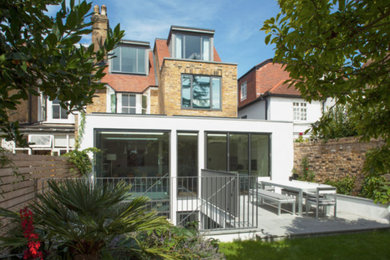 This is an example of a large contemporary house exterior in London with three floors.