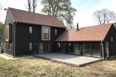 Minimalist black wood exterior home photo in Berkshire