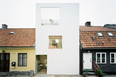 Idee per la facciata di una casa a schiera grande bianca contemporanea a tre piani con tetto piano e rivestimento in pietra