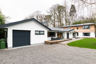 Design ideas for an expansive and multi-coloured contemporary two floor detached house in Kent with wood cladding, a pitched roof and a tiled roof.