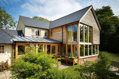 Design ideas for a large classic two floor house exterior in Berkshire with wood cladding.